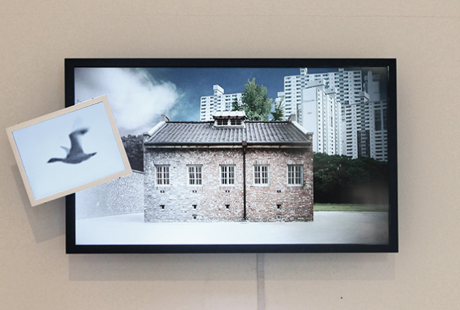 Guem MinJeong, The Wind-Up Bird Chronicle_Prison for Woman, 2014. 2 LED Monitor, Mixed Media, 65 x 150 x 15 cm.